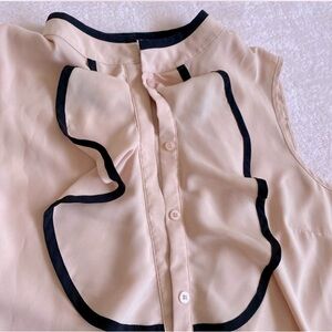 Elegant Cream Sleeveless Blouse with Black Trim